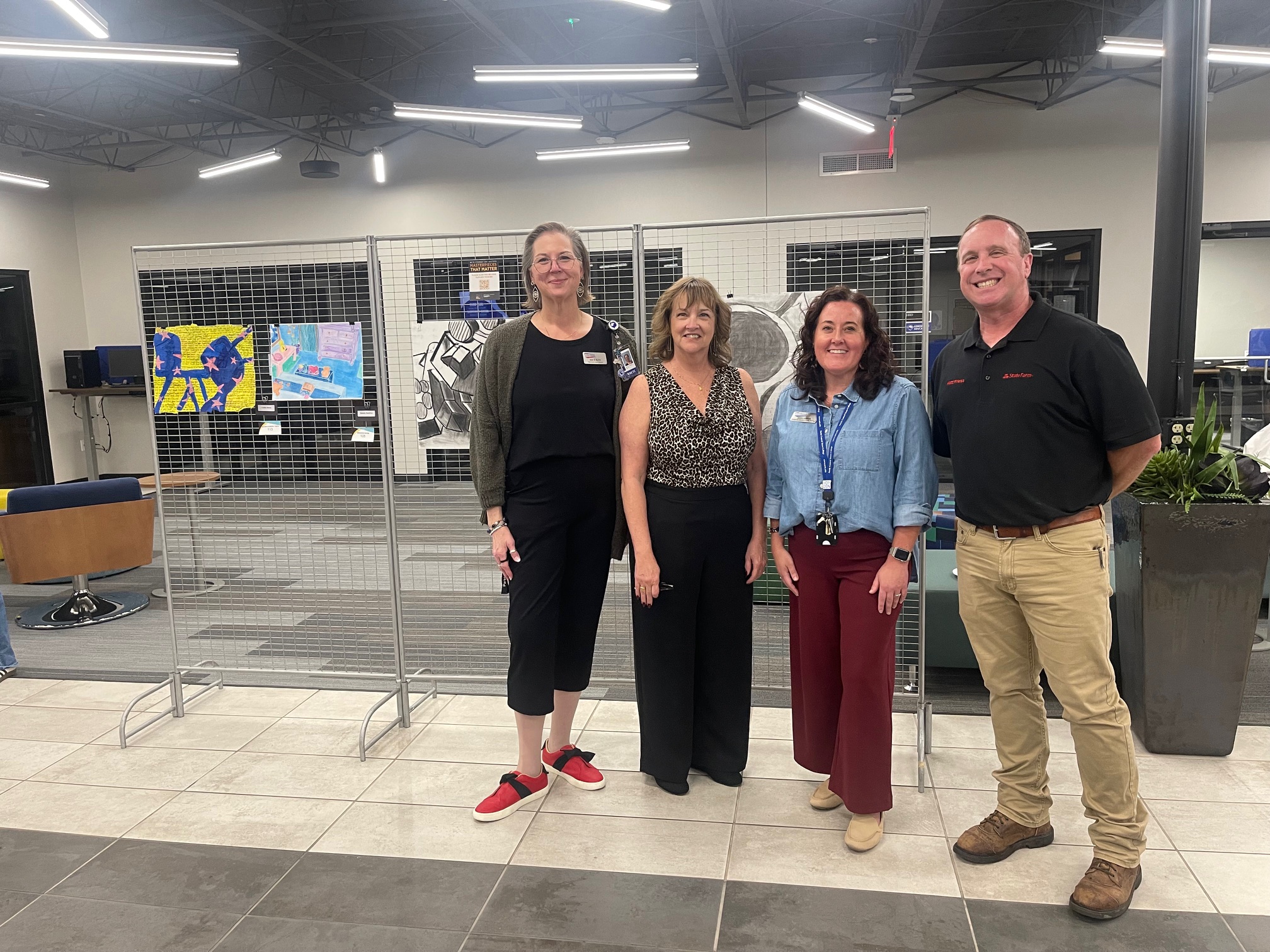 NCTC Foundation members stand with the student art.